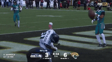 a seahawks football player is on the field with a fox nfl logo in the background