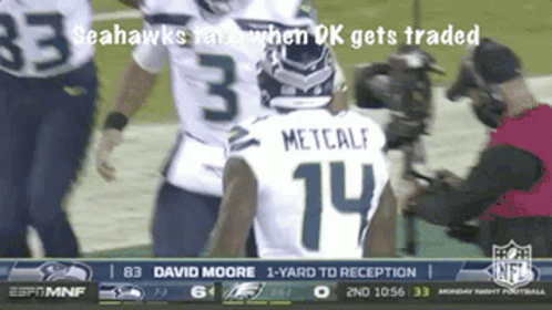 A Seahawks Player With The Number 14 On His Back GIF