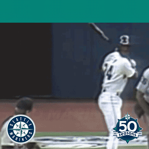 A Seattle Mariners Baseball Player Swings At A Ball GIF