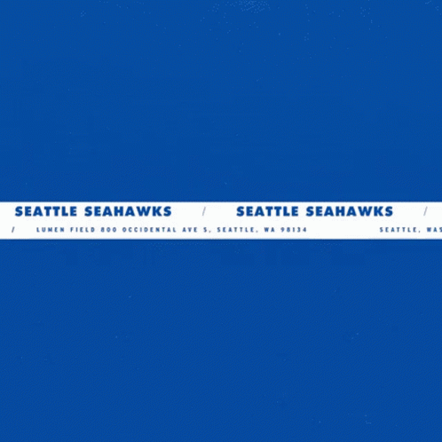 a seattle seahawks logo with a man holding a football