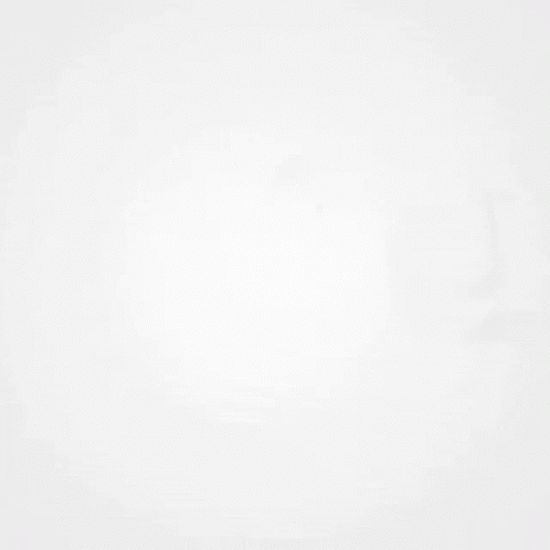 A Shadow Of A Clock Is Cast On A White Surface . GIF