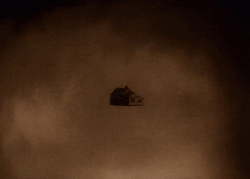A Shadow Of A House Is Cast On A Wall GIF