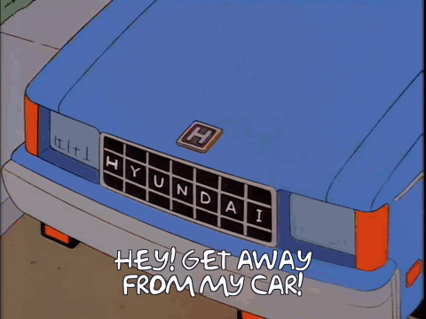 A Shadow Of A Man Is Cast On A Blue Hyundai GIF