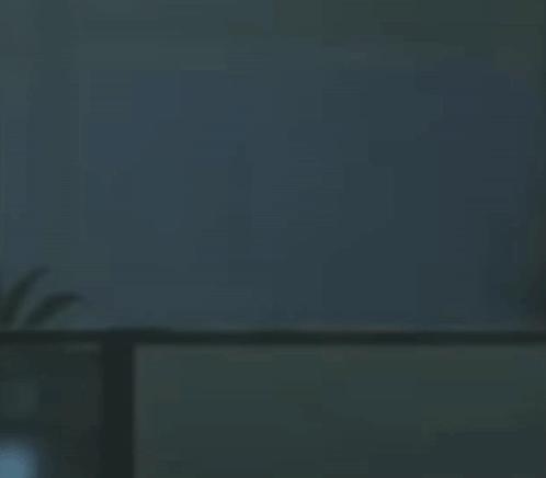A Shadow Of A Person Is Casting On A Wall In A Room . GIF