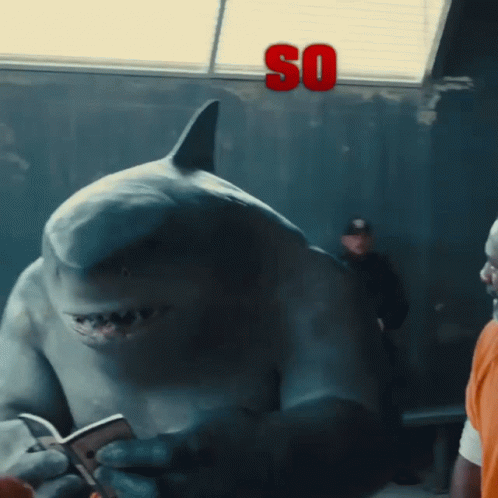 A Shark Is Holding A Cell Phone And The Word So Is Above It GIF