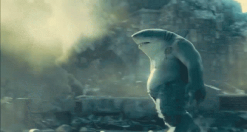A Shark Is Standing In Front Of A Building In A City . GIF