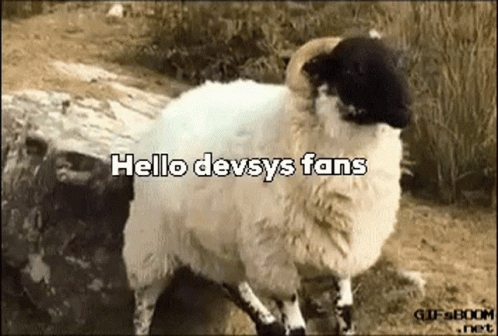 A Sheep With A Black Head Is Standing Next To A Rock With The Words `` Hello Devsys Fans '' Written On It . GIF
