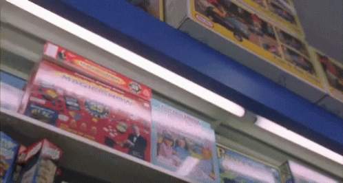 A Shelf Full Of Toys Including A Magic Show Box GIF