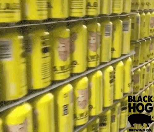 a shelf full of yellow cans of black hog brewing co. beer