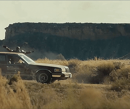 Sheriff's Car Driving Through Field GIF