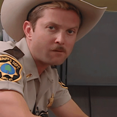 A Sheriff 'S Deputy Wearing A Cowboy Hat GIF