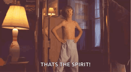 A Shirtless Boy Is Standing In A Room With His Hands On His Hips And Says That 'S The Spirit .. GIF