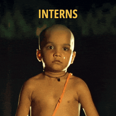 A Shirtless Child With The Word Interns Behind Him GIF