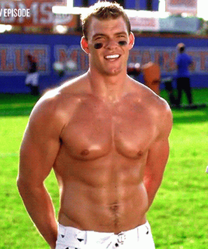 A Shirtless Football Player Stands In Front Of A Sign That Says Episode GIF