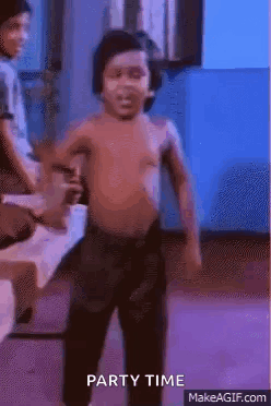A Shirtless Little Boy Is Dancing In A Room With A Blue Background . GIF