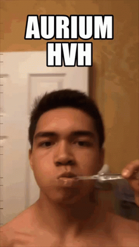 A Shirtless Man Brushing His Teeth With The Words Aurium Hvh Below Him GIF