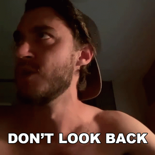 A Shirtless Man In A Baseball Cap Says " Don T Look Back " GIF