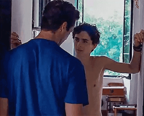 A Shirtless Man In A Blue Shirt Is Standing Next To A Shirtless Man In A Blue Shirt . GIF