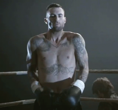 A Shirtless Man In A Boxing Ring Has A Tattoo On His Chest That Says " I Am " GIF