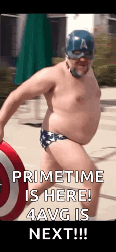 A Shirtless Man In A Captain America Costume Is Holding A Shield And A Ball . GIF