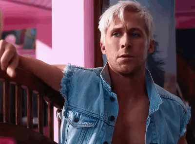 A Shirtless Man In A Denim Vest Is Leaning On A Wooden Railing . GIF
