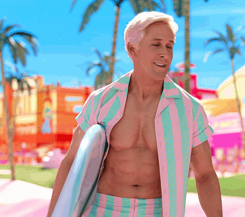 A Shirtless Man In A Pink And Green Striped Shirt Holds A Surfboard GIF