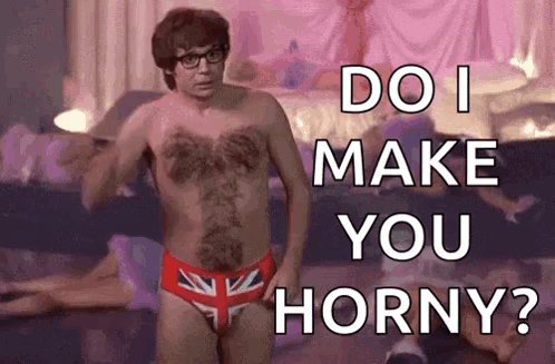 A Shirtless Man In British Flag Underwear Is Standing In Front Of A Bed And Asking Do I Make You Horny ? GIF