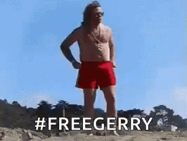 A Shirtless Man In Red Shorts Is Standing On A Beach And Says `` Freegerry '' . GIF