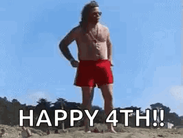 A Shirtless Man In Red Shorts Is Standing On A Beach And Says `` Happy 4Th ! '' GIF