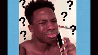 A Shirtless Man Is Crying While Talking On A Cell Phone With Question Marks Around His Head . GIF