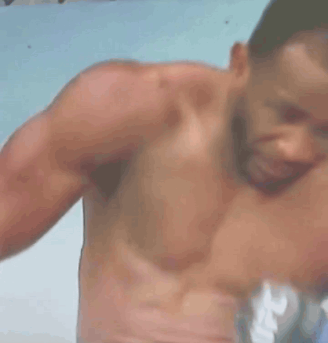 A Shirtless Man Is Crying With A Straw In His Mouth GIF