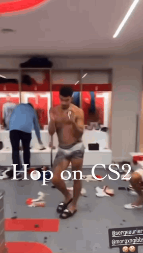 A Shirtless Man Is Dancing In A Locker Room With The Words `` Hop On Cs2 '' Written Above Him . GIF