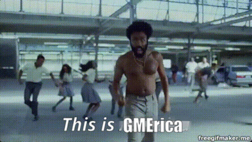 A Shirtless Man Is Dancing In A Parking Garage With The Words This Is Gmerica Above Him GIF
