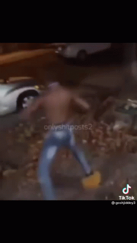 A Shirtless Man Is Dancing In Front Of A Silver Car GIF