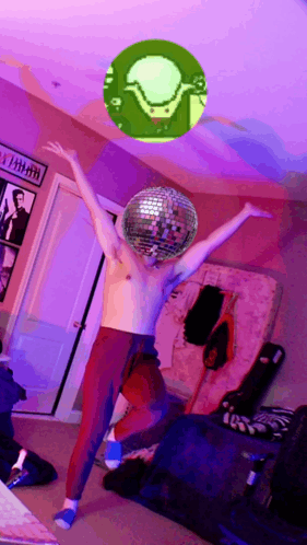 A Shirtless Man Is Dancing With A Disco Ball In Front Of His Head GIF