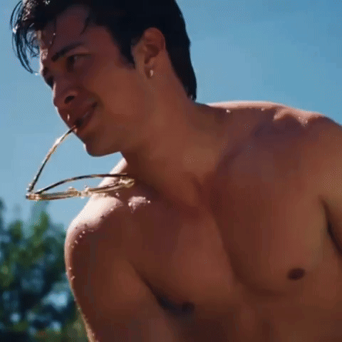 A Shirtless Man Is Drinking Water From A Straw GIF