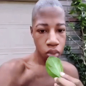 Shirtless Man Eating Green Leaf GIF