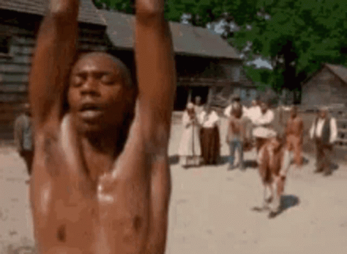 A Shirtless Man Is Hanging Upside Down With His Arms In The Air . GIF