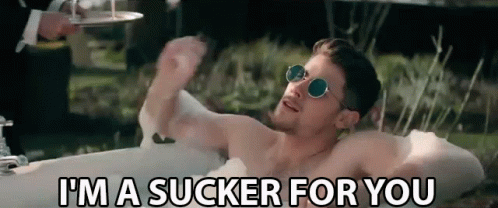 A Shirtless Man Is Laying In A Bathtub And Saying I 'M A Sucker For You . GIF
