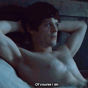 A Shirtless Man Is Laying On A Bed And Saying Of Course I Do GIF