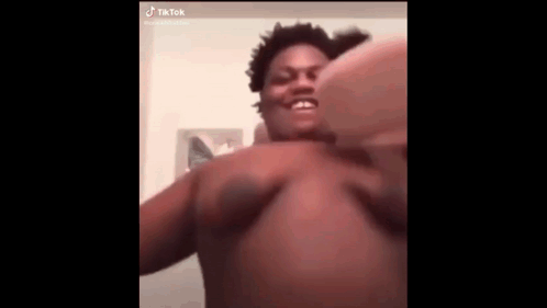 a shirtless man is making a funny face while taking a selfie .