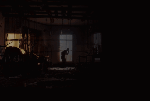 a shirtless man is riding a white horse in a dark room