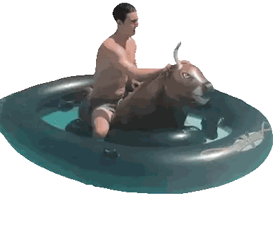 a shirtless man is riding an inflatable bull