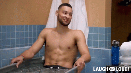 A Shirtless Man Is Sitting In A Bathtub With The Words Laugh Out Loud Behind Him GIF