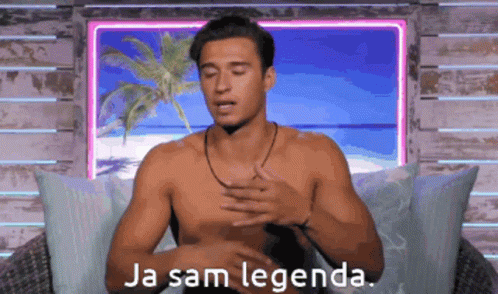 A Shirtless Man Is Sitting In Front Of A Window With The Words Ja Sam Legenda Written On It GIF