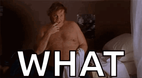A Shirtless Man Is Sitting On A Bed And Smoking A Cigarette And The Word What Is Above Him . GIF