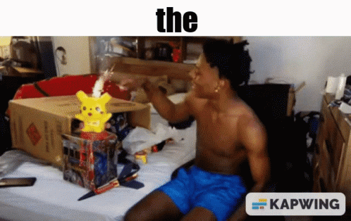 A Shirtless Man Is Sitting On A Bed With A Pikachu In A Box And A Caption That Says " The " GIF