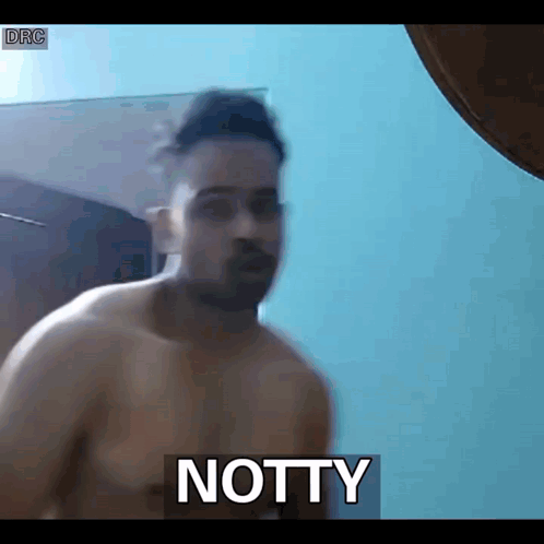 Shirtless Man Standing In Front Of Notty GIF