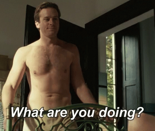 A Shirtless Man Is Standing In Front Of A Door And Asking " What Are You Doing " GIF