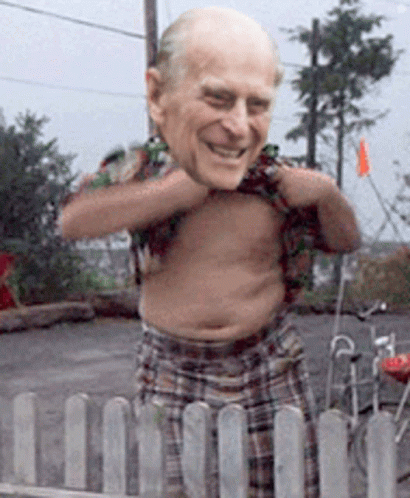 A Shirtless Man Is Standing In Front Of A Fence GIF